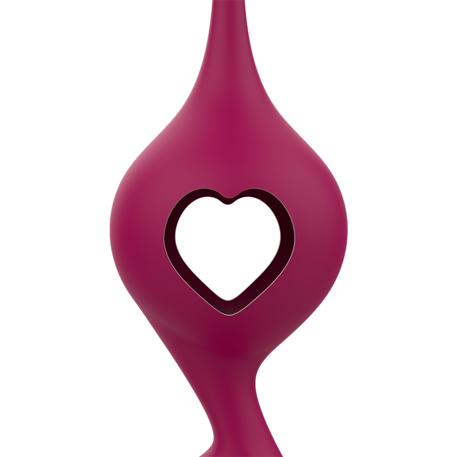 Gros plan sur une boule de Geisha Rithual en silicone bordeaux au coeur ajoure, surface lisse non anatomique, element du kit a poids progressifs pour tonifier le perinee.