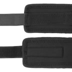 Menottes Darkness en neoprene noir presentees ouvertes a plat, fermeture velcro et doublure soyeuse, pour une restriction des poignets douce et confortable.