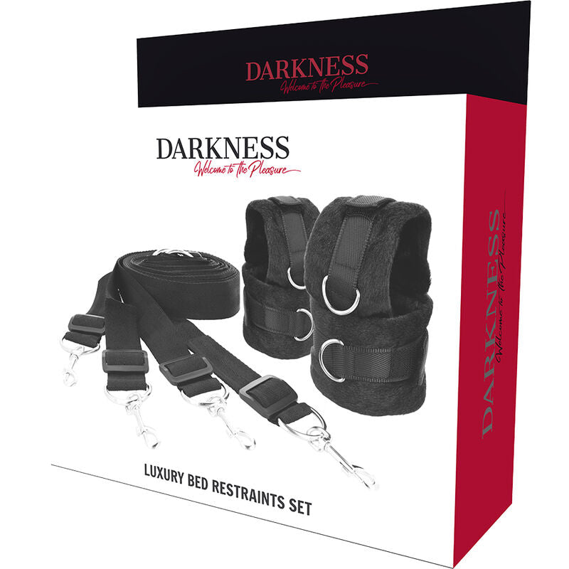 Packaging Darkness Luxury Bed Restraints Set avec sangles noires, manchettes fourrure a anneaux D et mousquetons, kit complet de retenue lit pour le bondage en couple.