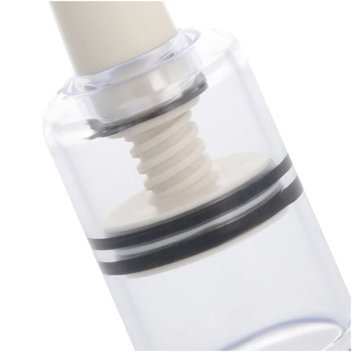 Gros plan sur une ventouse a teton Darkness : cylindre transparent, vis d aspiration et anneaux d etancheite pour doser la succion sur le mamelon.