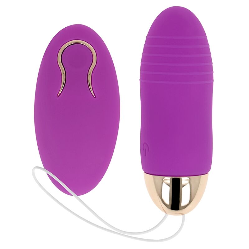 Oeuf vibrant violet strie avec embout dore, pose a cote de sa telecommande